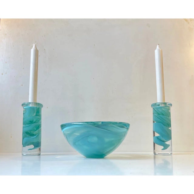 Thick and heavy conical art glass bow and two matching candlesticksl from Kosta Boda in Sweden. Designed by Anna Ehrner in...