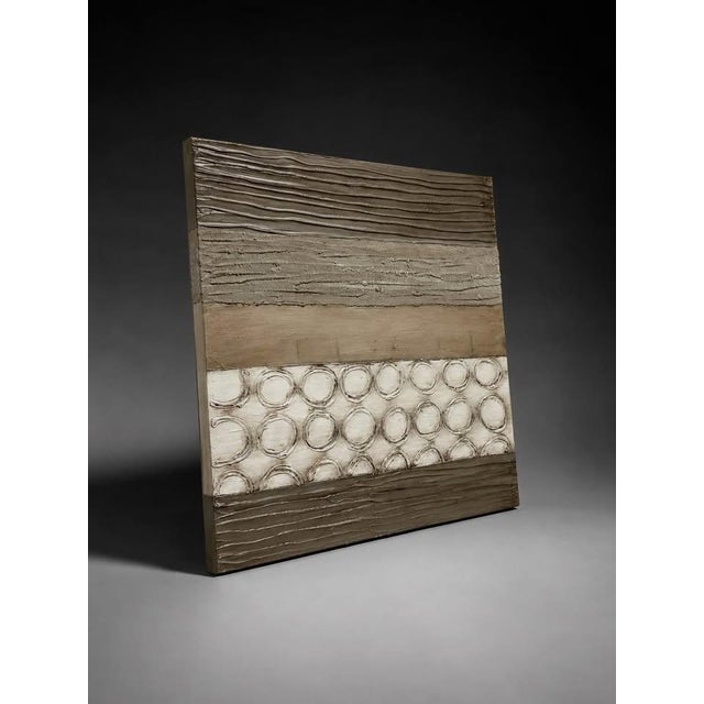 Modern textured abstract wall art featuring neutral brown, beige, taupe, cream, and earthy gray tones. The raised circular...
