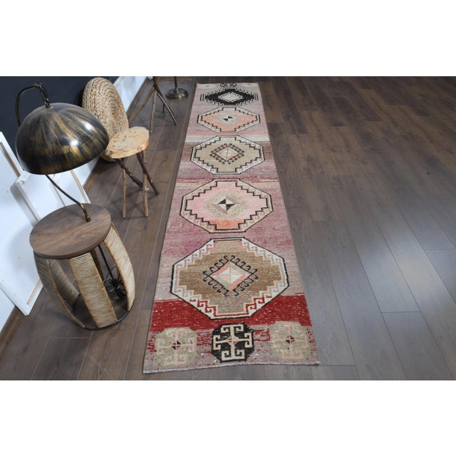 Vintage Turkish Hand-Knotted vintage rug is a semi-antique vintage runner rug. The '70s Eastern region of Turkey's unique...