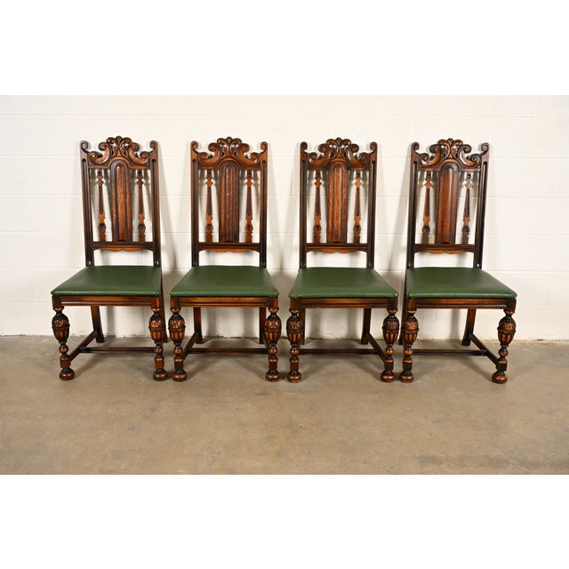 A beautiful set of four antique English Jacobean or Tudor style dining chairs By Berkey & Gay USA, Circa 1920s Carved...
