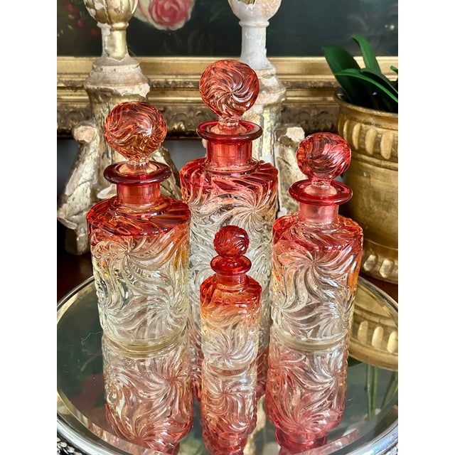 Beautiful collection of four antique French Baccarat crystal perfume/cologne bottles in the harder to find Cadmium...