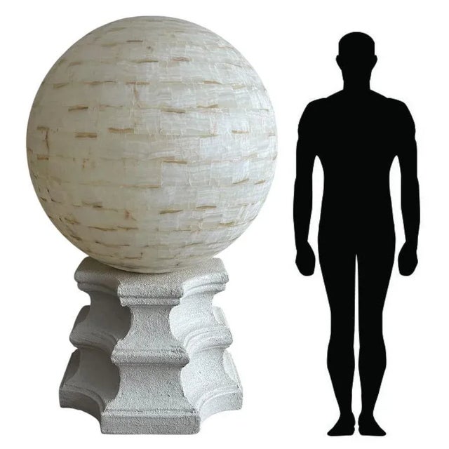 Striking and monumental pair of oversized floor lamps, each featuring a sculptural base supporting a massive hand-crafted...