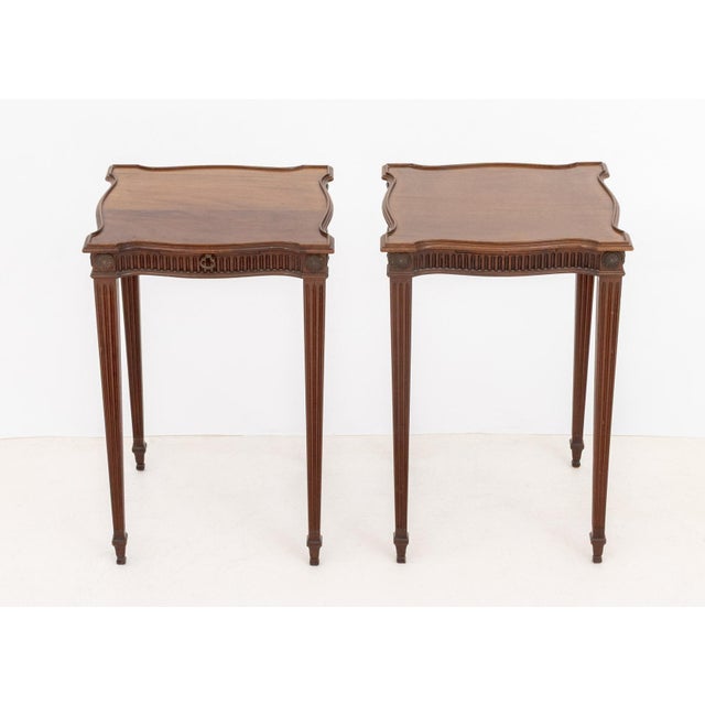 Near Pair of Louis XVI Style Mahogany Side Tables, with serpentine top with rosettes on four fluted tapered legs. 24" H x...