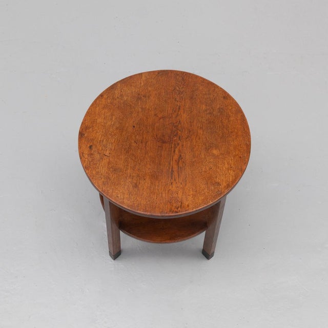 Amsterdam School side table from the 1920s–30s, crafted in solid oak with dark stained accents and characteristic...