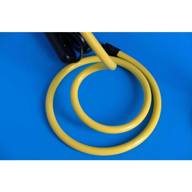 A striking pair of vintage desk lamps in vibrant yellow, perfectly capturing the playful and bold spirit of postmodern...