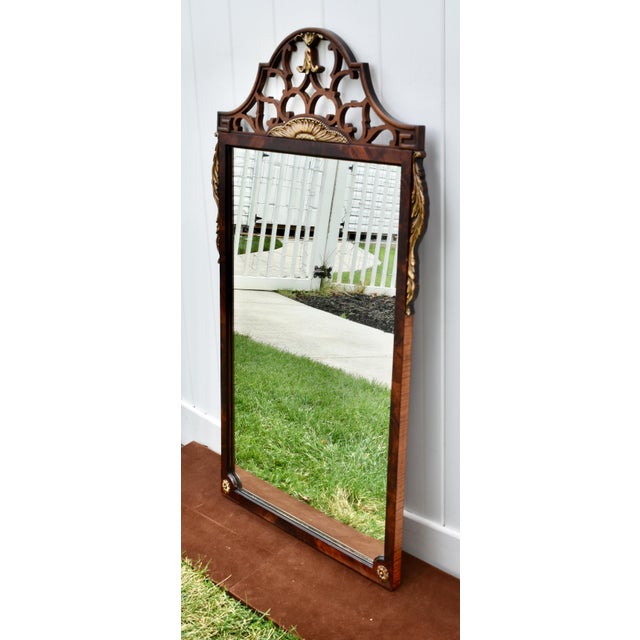 Antique (1920's) Wall Mirror has a Chippendale Style. Made of Wood. Mahogany. Carved Wood. Intricate Fretwork at the Top...