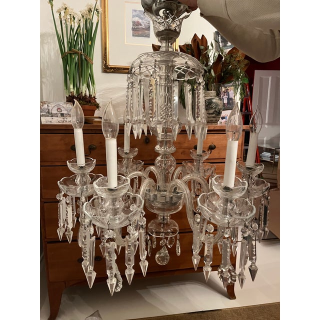 A stunning vintage crystal and blown glass chandelier in the style of Baccarat. The light features six lights and has no...