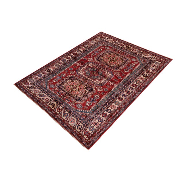 Enhance your home with this exquisite hand-knotted Super Kazak rug, crafted from fine hand-spun wool and dyed with all-...