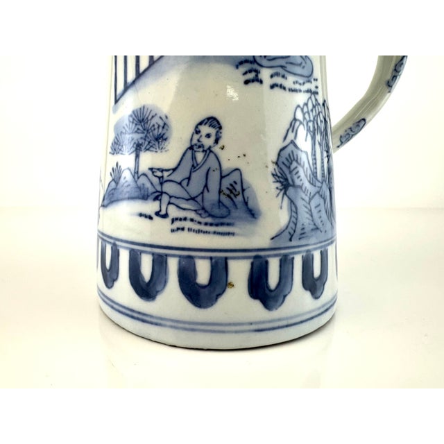 This elegant porcelain tankard captures the essence of traditional Chinese export ware with its refined blue and white...