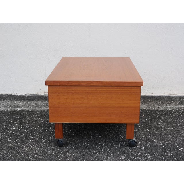 Mid-century modern style low side table with shelf below, mounted on four casters to roll where you need it most. This...