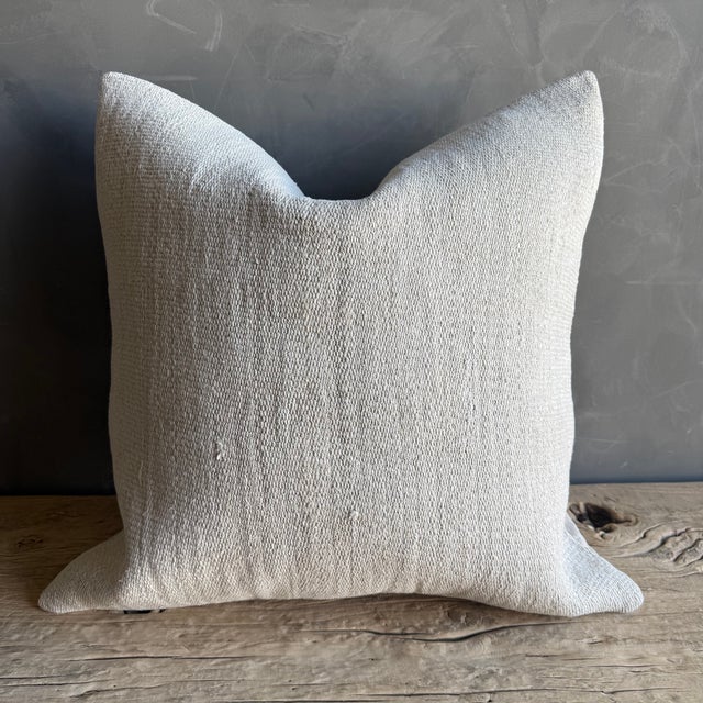 Creamy white hemp rug pillow with original seams. Soft hand, linen blend backing with zipper closure. Spot cleaning is...