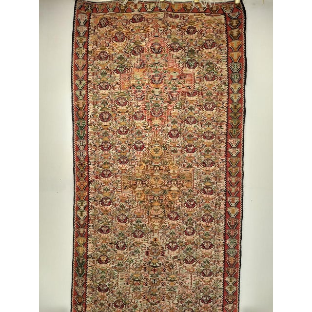 "This early 20th century Persian Senneh kilim in a runner format is an extraordinarily rare and highly collectible piece....