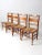 This is a collection of four vintage Tell City Furniture chairs. The Hitchcock style chairs feature rush seats and a...