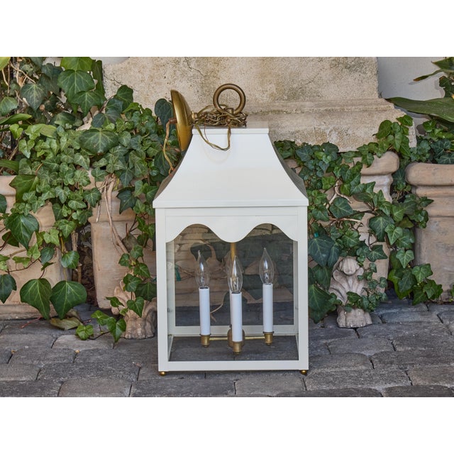 This Midcentury white painted metal lantern offers a striking combination of architectural lines, soft curves, and...