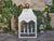This Midcentury white painted metal lantern offers a striking combination of architectural lines, soft curves, and...