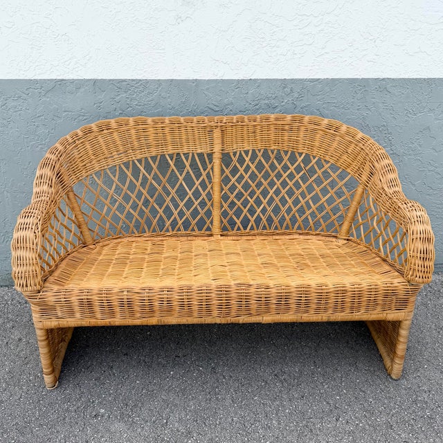 A beautifully crafted Vintage Boho Chic woven wicker loveseat featuring an elegant sculptural silhouette and intricate...