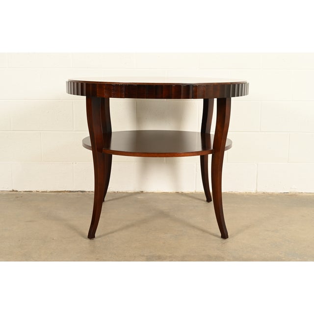 An elegant modern Regency or Art Deco style dark mahogany two-tier game table or center table By Barbara Barry for Baker...
