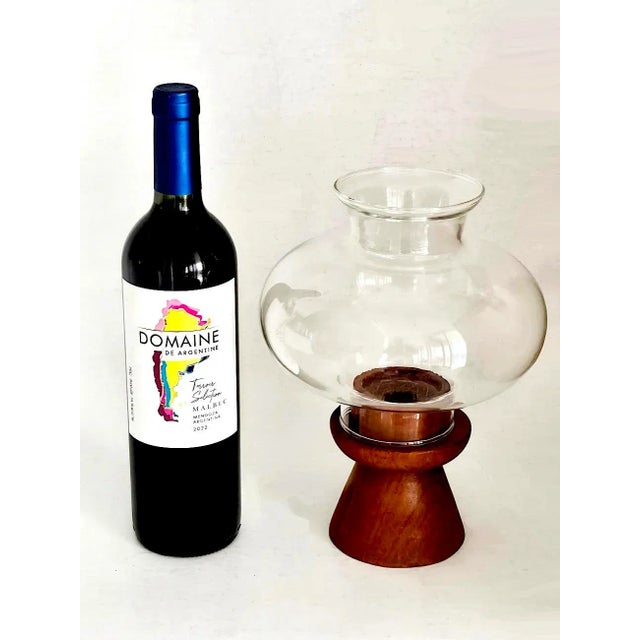 Offered is a mid 20th century teak wood candle holder with a hand blown glass chimney cover, known as a hurricane lamp....