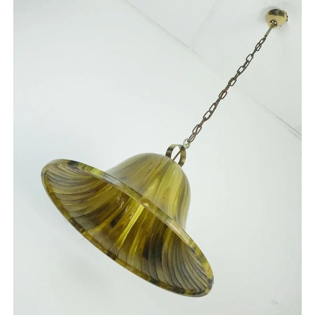 Impressive 1970s pendant light made of amber color acrylic and brass. For 1 bulb with E27 socket. Dimensions in cm:...
