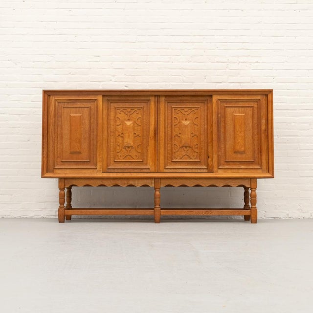Rare oak sideboard designed by Axel O. Röck for Otterup Møbelfabrik, Denmark 1963. The cabinet features four sliding...
