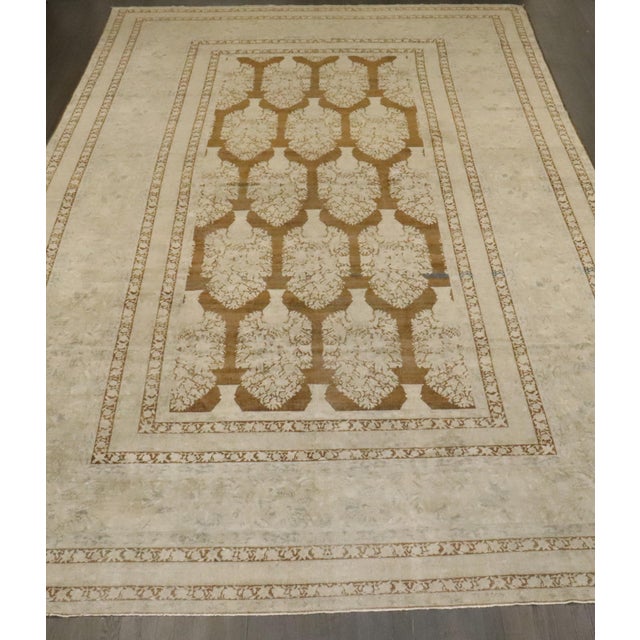 An early 20th Century Indian Larestan Rug with an all-over large scale plant vase pattern on a brown field