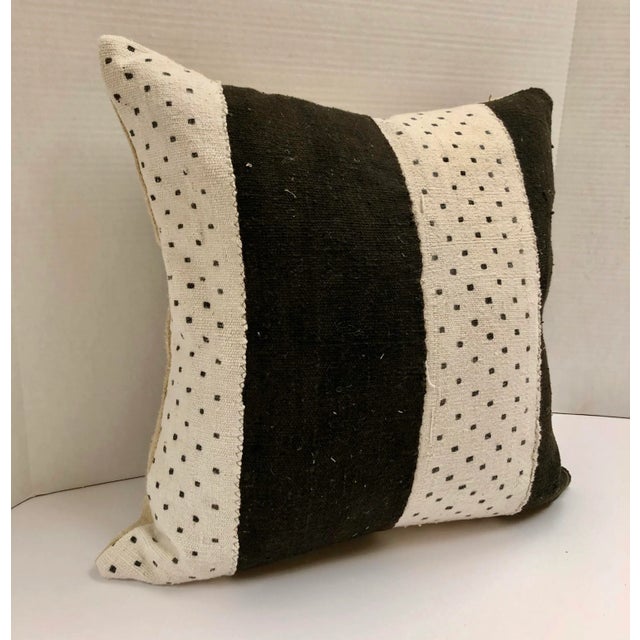 Mud cloth is made in Mali Africa. It is constructed of hand-spun cotton strips. The fabric is then dyed in a bath made of...