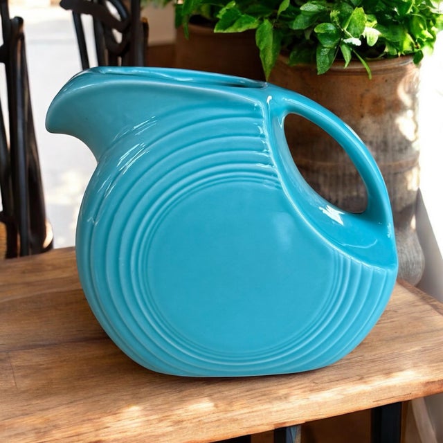 Excellent condition late 20th century Fiesta-ware disc water pitcher in beautiful turquoise. Dimensions 7” tall x 7.5”...