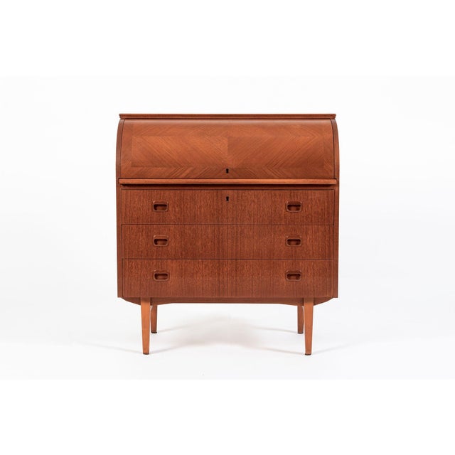 This vintage mid-century Swedish modern Egon Ostergaard teak rolltop secretary desk cabinet was made in Sweden circa 1960....