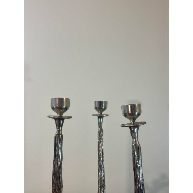 A sculptural mid century modern three-light candelabra designed and signed by Castor Cooper. Cast in pewter with an...