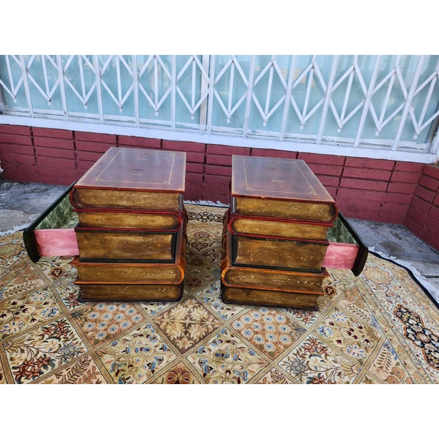 Unique side tables are constructed with a faux stacked book design. Each table has a wood-like finish with leather-...