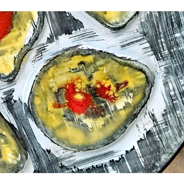 A Complete Set of Twelve Hand-Painted MBFA Pornic Pottery Oyster Plates This exceptional collection of twelve French...