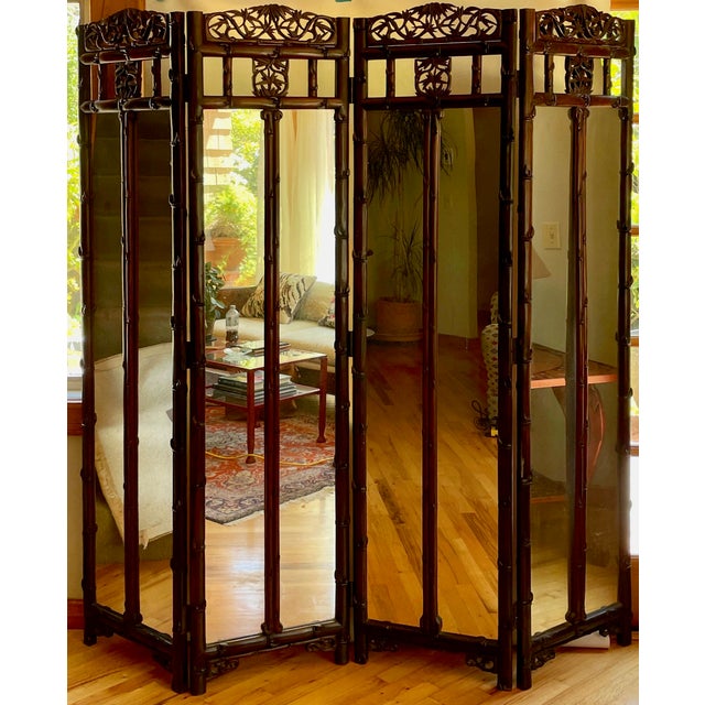 This is a very special and unusual teak wood screen aged to a rich dark brown. It has four panels with hand-carved frames...