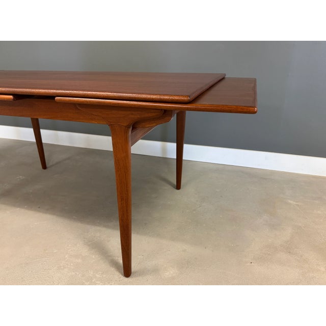 A mid century modern teak draw leaf dining table . Made in Denmark. Professionally refinished. Circa 1960’s. Fully expands...