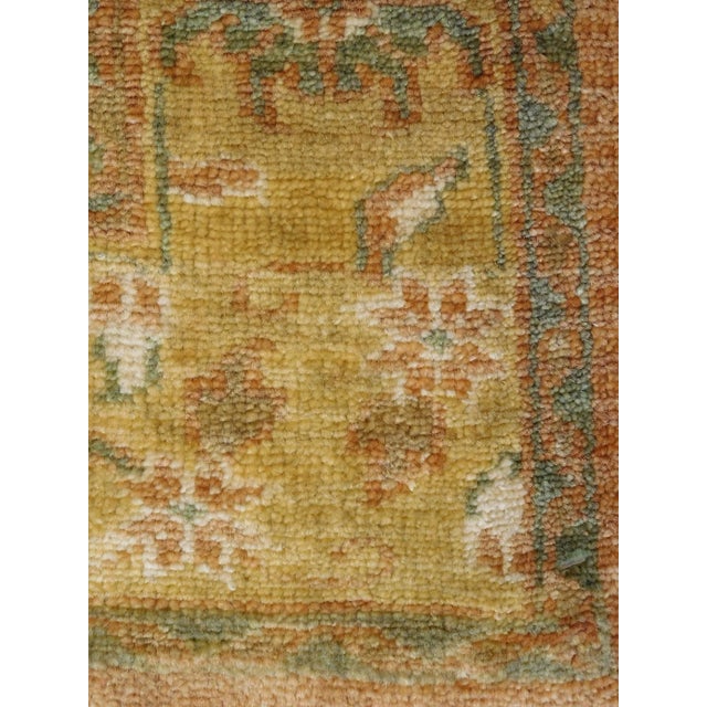 Hand-knotted Oushak style Rug. Geometric ivory medallion, flanked on both ends, on a plain background, with reciprocating...