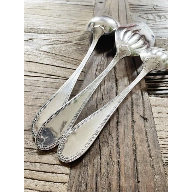 An antique silver plated large serving set made by Tiffany & Co in the 1903 Norman pattern. The set consists of a large...