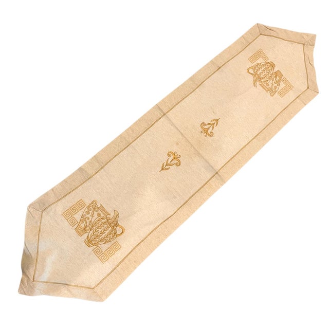 Beautiful table runner with a gold embroidery of Greek-style geometric symbols and pitchers embroidered with foliage on...