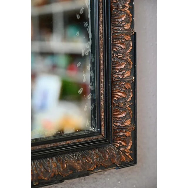 This pretty mirror has a frame with golden and plant patterns, in relief. Nice old wall decoration with bohemian charm, it...