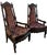 A striking matched pair of antique Victorian Eastlake armchairs dating to the late nineteenth century, crafted from richly...