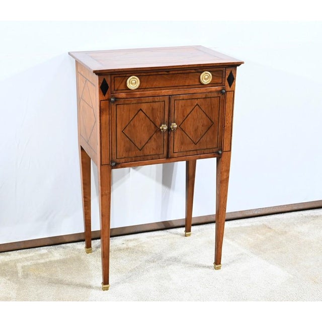 Small solid walnut furniture with a chiseled rings drawer and bronze mascarons on a belt with inlays of ebony nets on its...