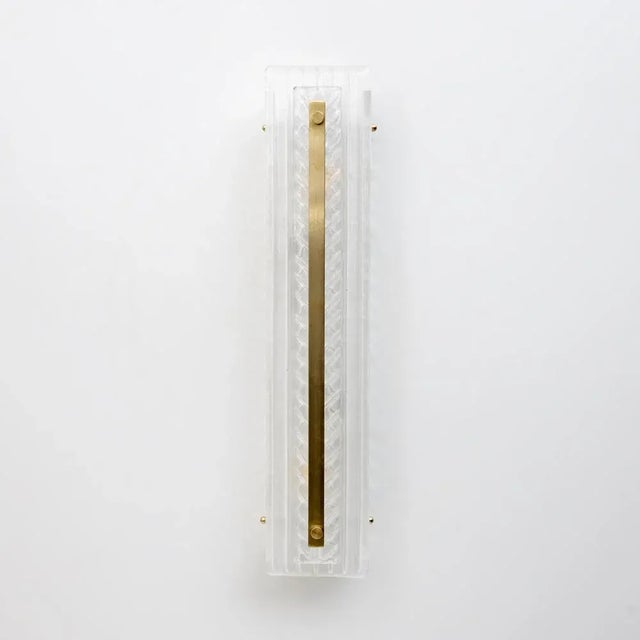 Pair of textured Murano glass wall lamps in natural crystal. Each sconce features three Murano glass elements with a...