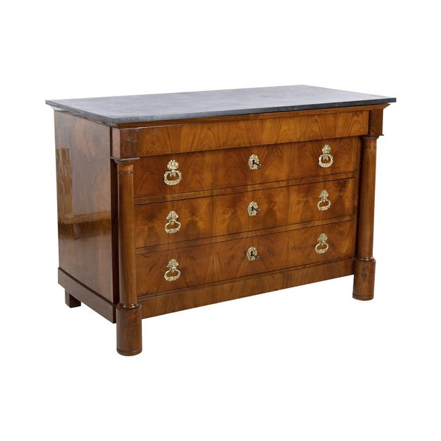 A large Empire chest of drawers veneered with four spacious drawers. The top drawer without handles as cornice. On the...