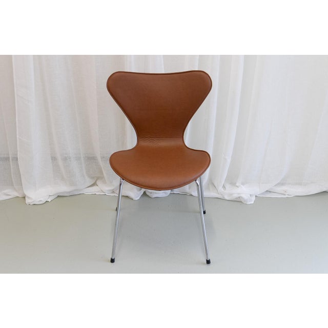Series 7 Chair by Arne Jacobsen for Fritz Hansen, 2001. Arne Jacobsen stacking dining chairs Model 3107 with cognac...