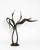 A contemporary animal bronze of two storks caught in their courtship dance, necks stretched to the sky and golden beaks...