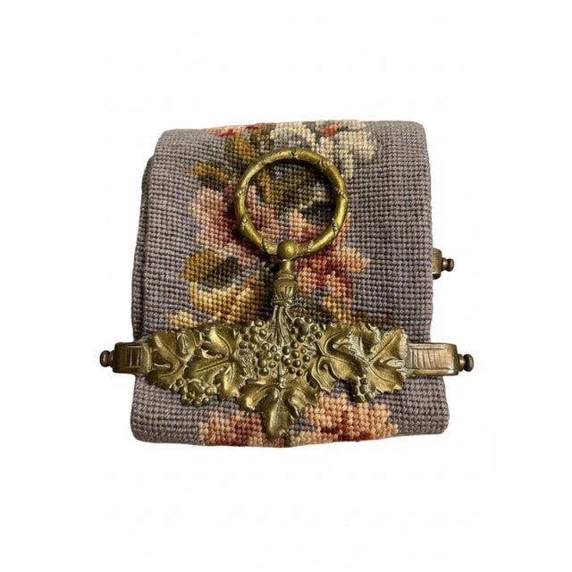 Vintage decorative needlepoint bell pull featuring an elegant repeating floral design worked against a soft gray ground....