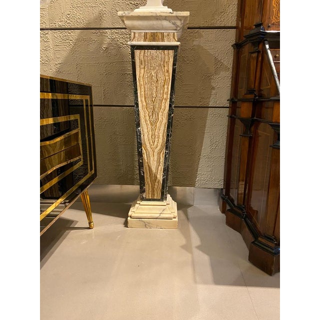 This elegant tapered pair of pedestals are raised by rectangular mottled edge white Carrara marble bases. The tapered...