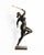 A contemporary figurative bronze of a woman mid-swing, racket raised high overhead, weight poised on one leg in the moment...