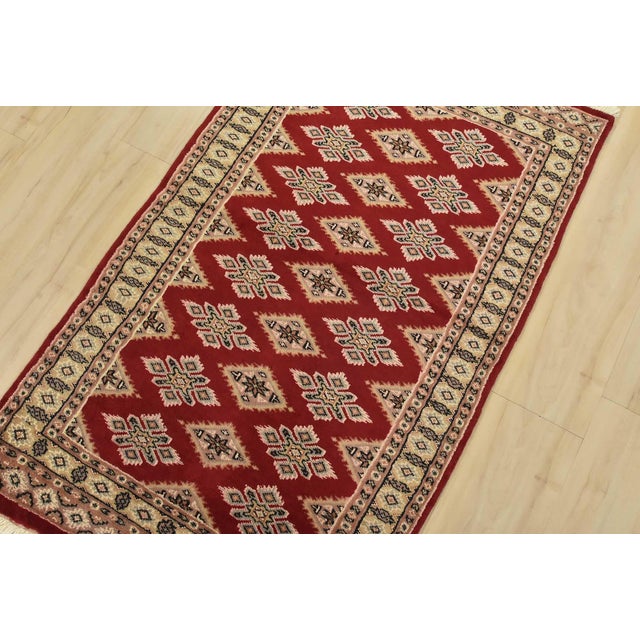 A tribal Bokhara Jaldar rug hand-knotted with fine wool on a cotton foundation. This rug features rows of repeating...