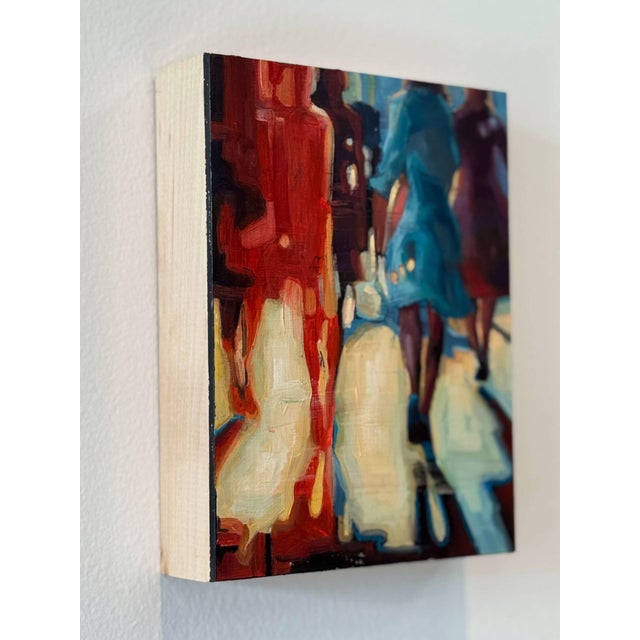Streets of Hope 3 captures the essence of urban life through the blurred figures of pedestrians moving through a vibrant...