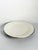 Large French ceramic serving platter dating from the 1980s, featuring a simple oval form finished in a warm white glaze. A...