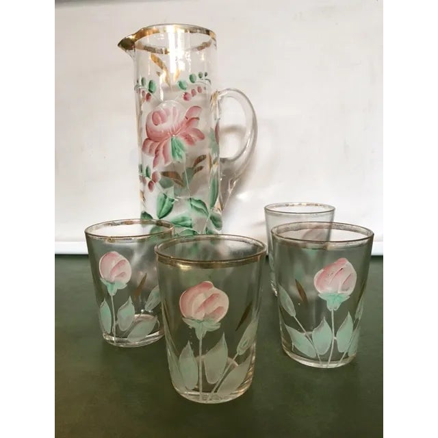 Beautiful antique glass and pitcher set. The gold-rimmed set includes 4 glasses and a tall pitcher. The tumbler glasses...